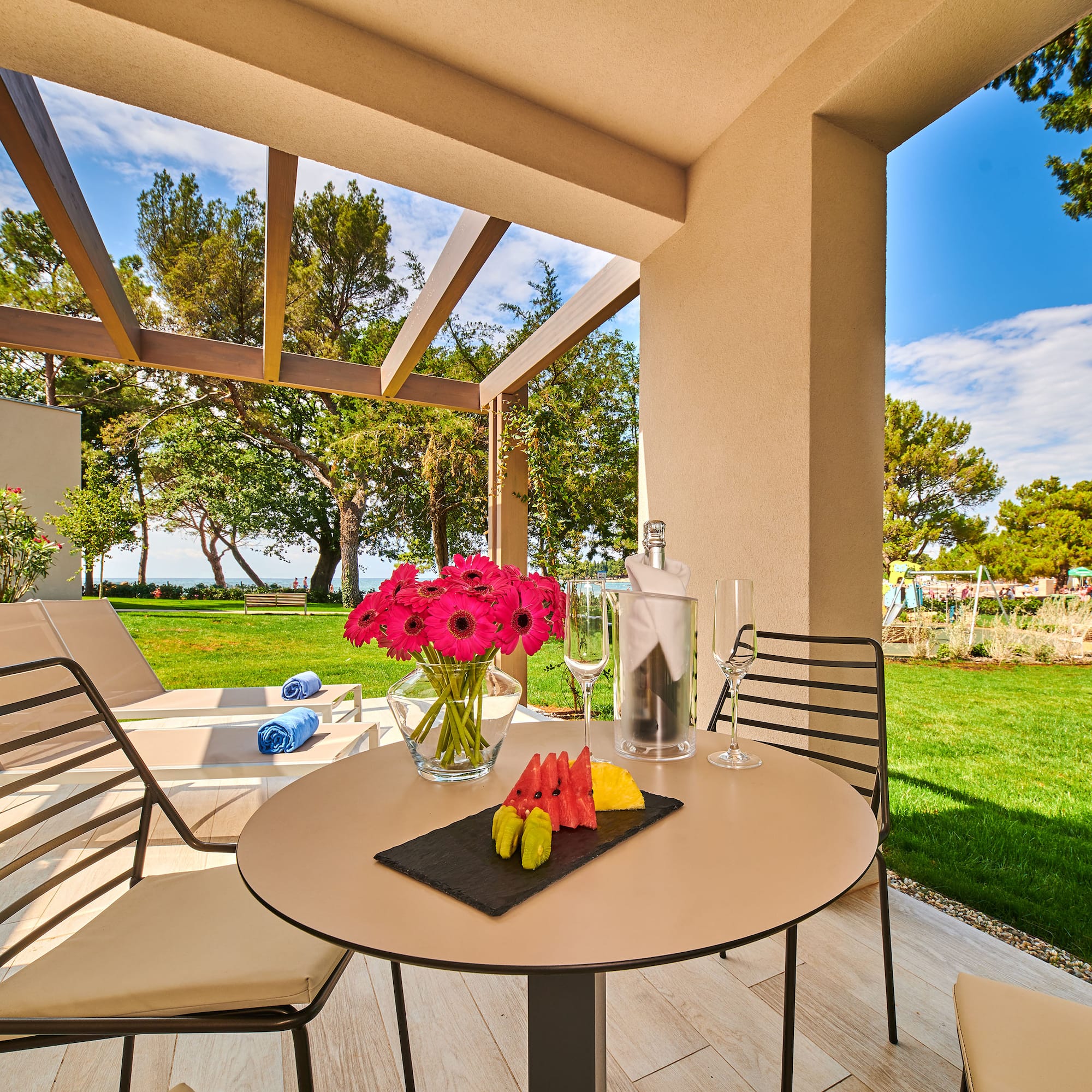 a table with fruit and wine glasses on it