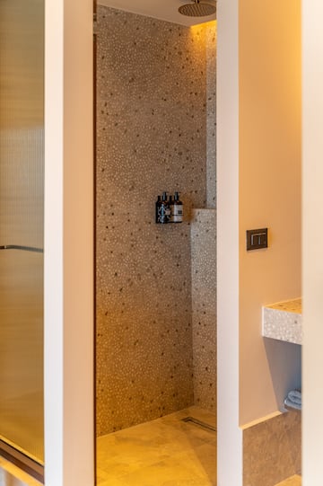 a shower with a shower and a sink