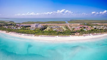a beach with buildings and trees