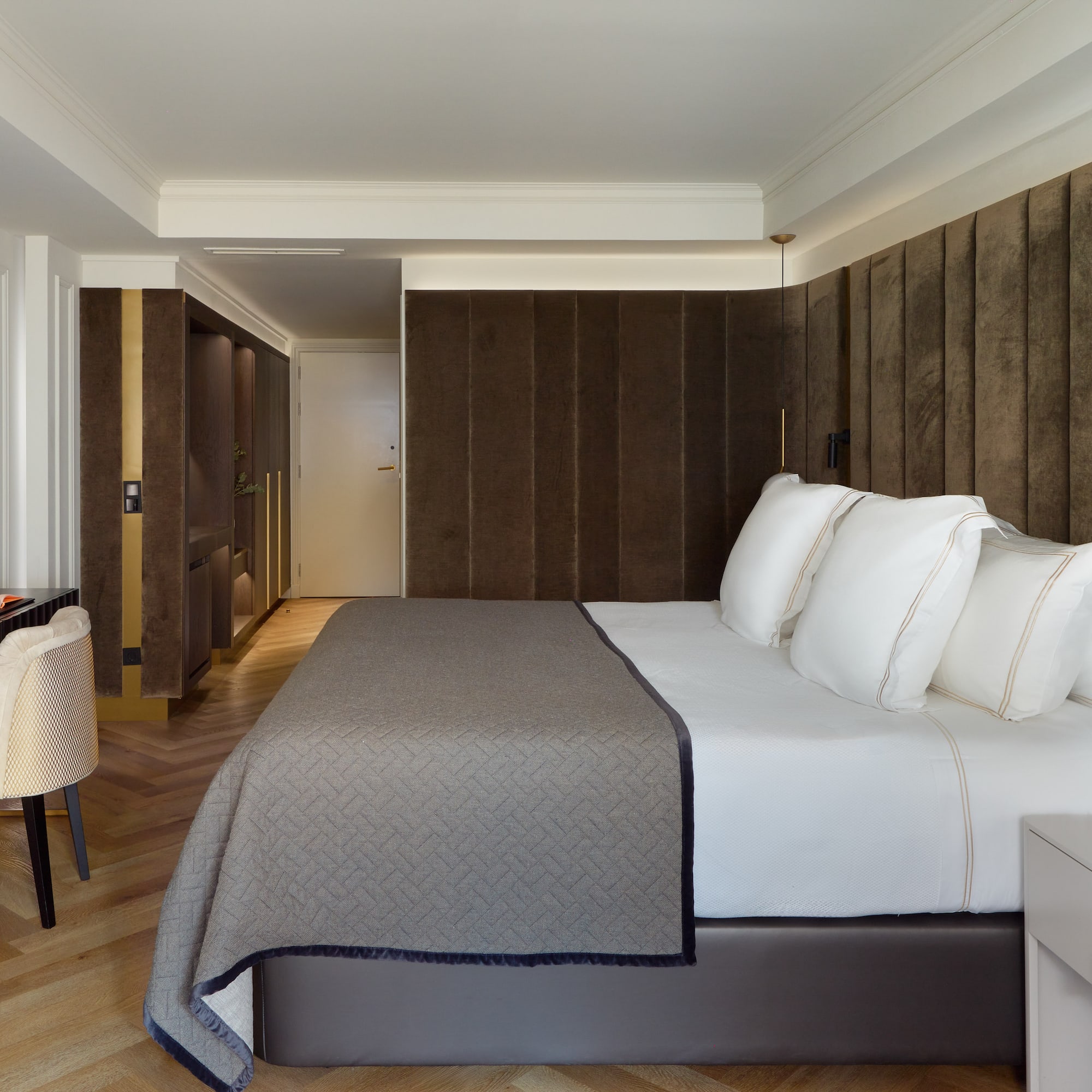 a bed with white pillows in a room