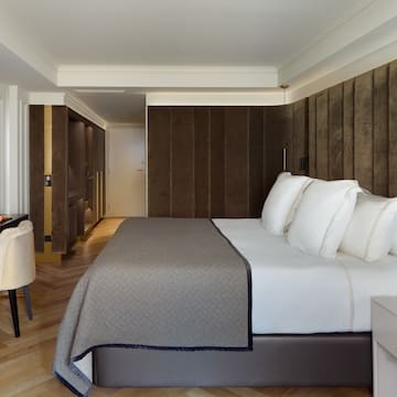 a bed with white pillows in a room