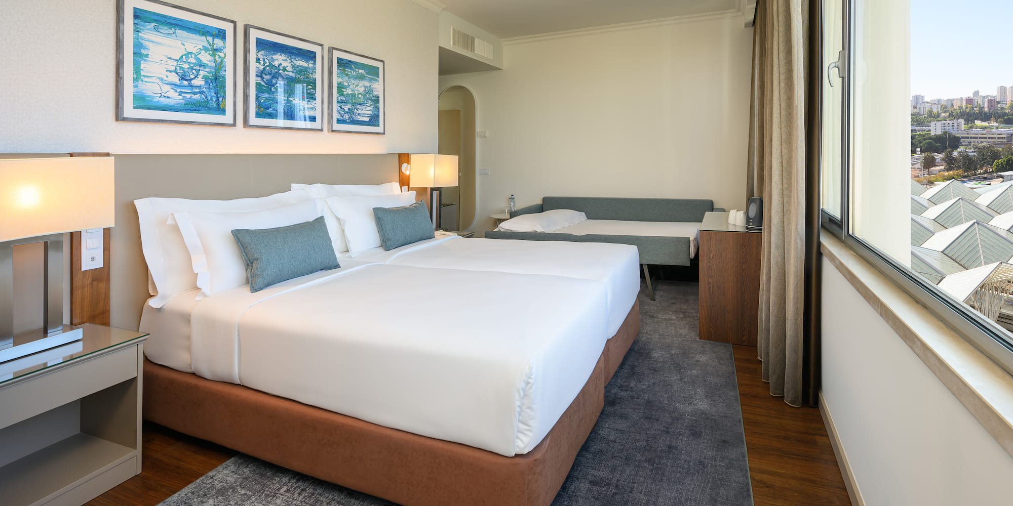 a room with two beds and a window