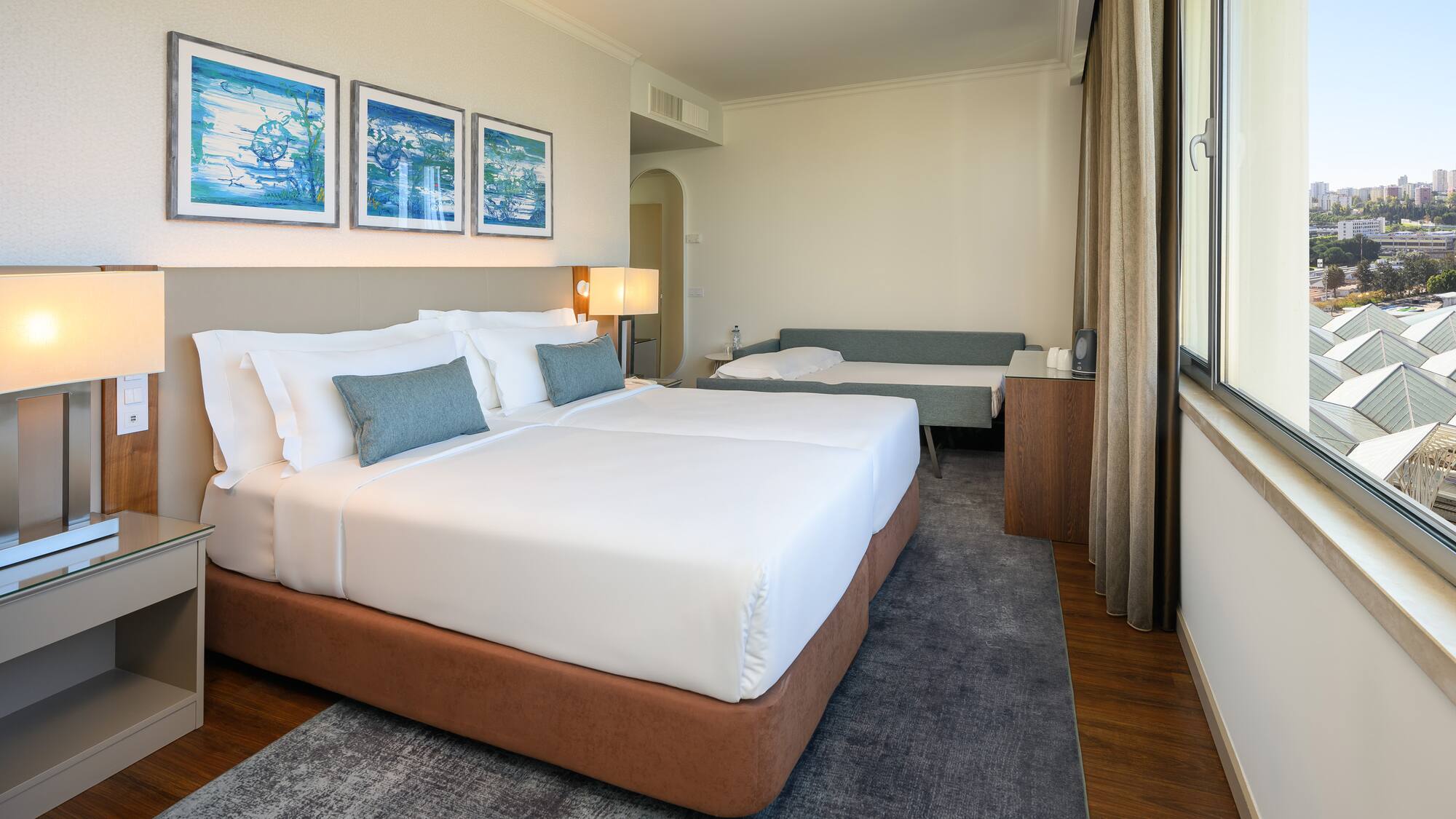 a room with two beds and a window