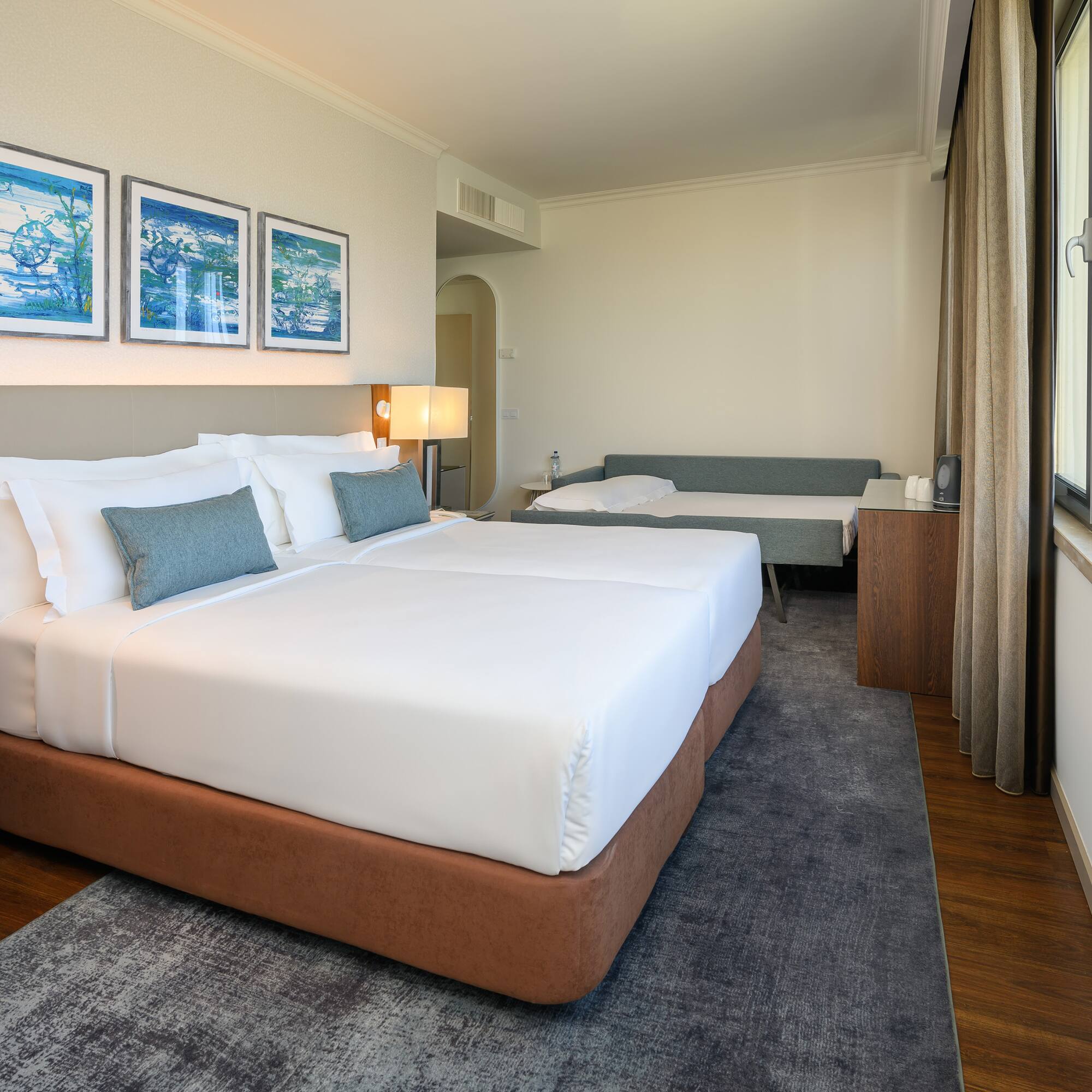 a room with two beds and a window