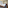 Modern hotel room with twin beds, sofa bed, city view, and blue art.