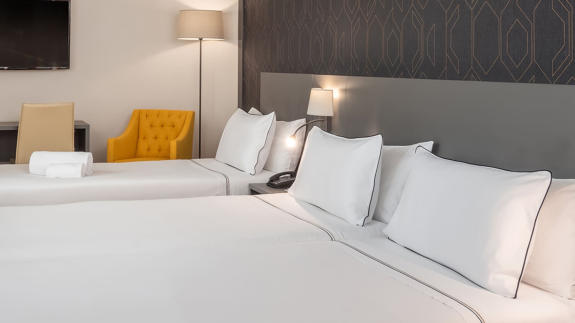 a room with two beds and a tv