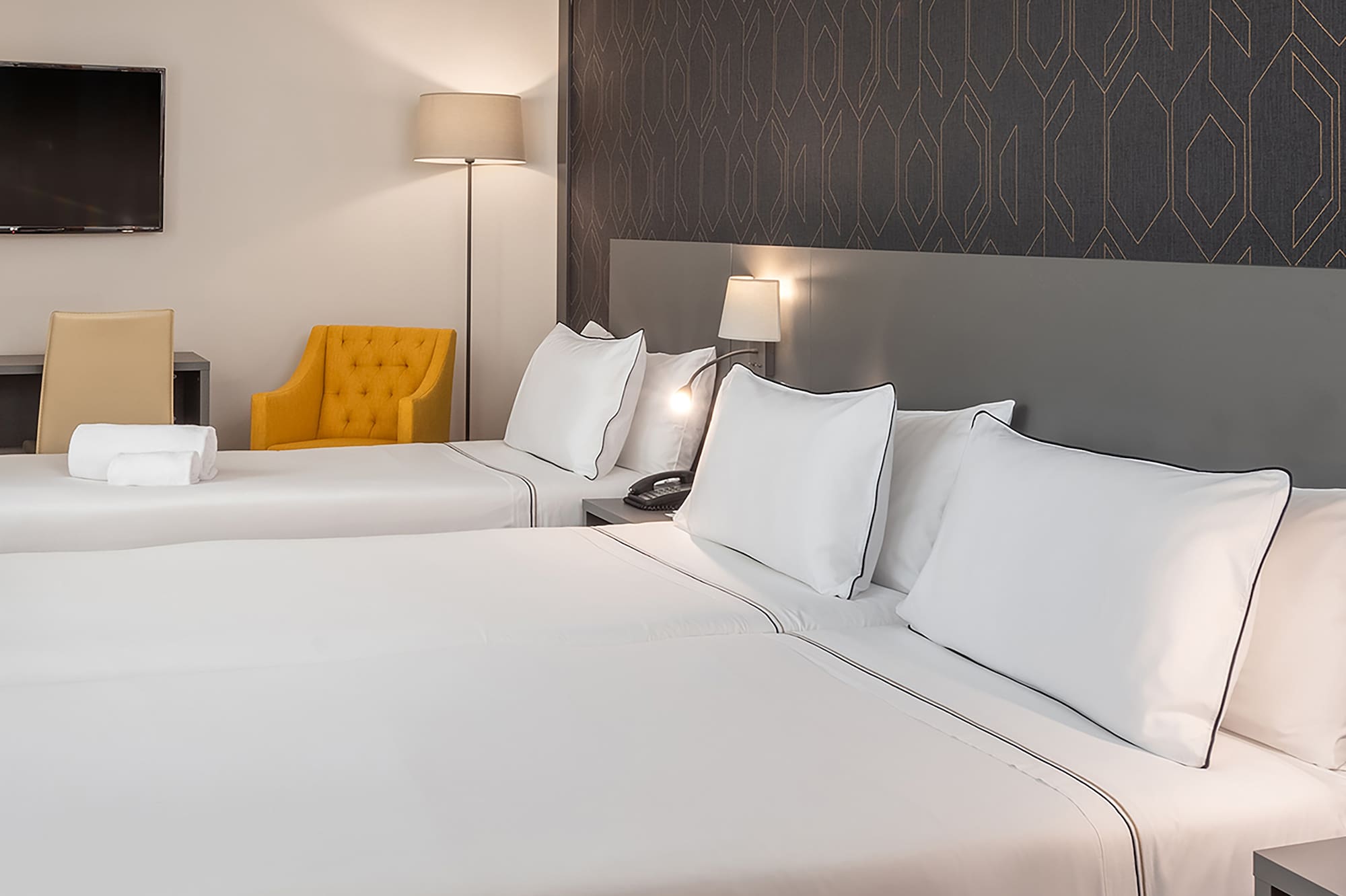 a room with two beds and a tv