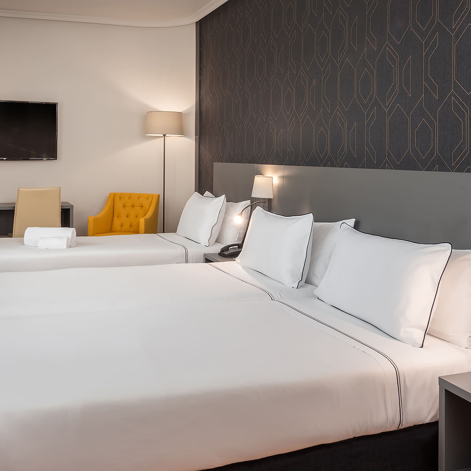 a room with two beds and a tv