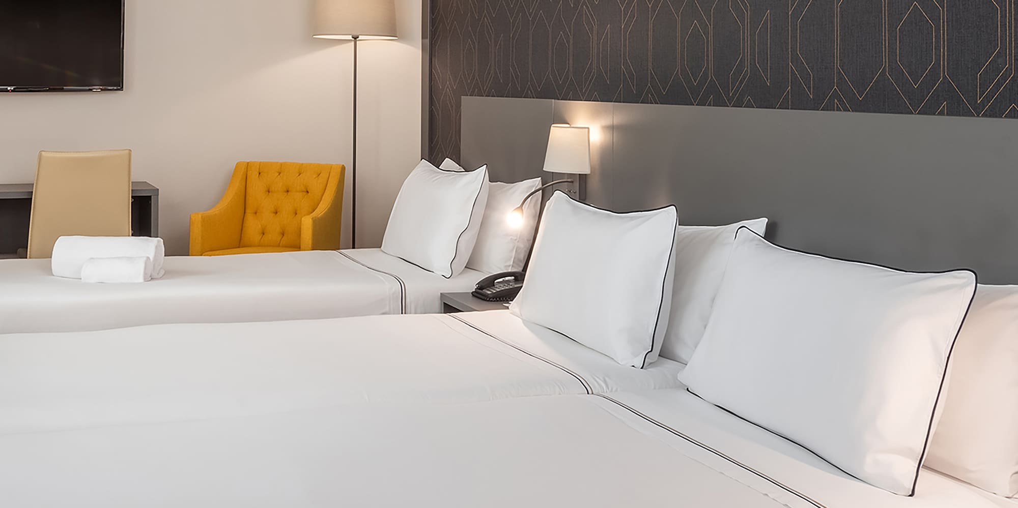 a room with two beds and a tv