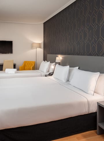 a room with two beds and a tv