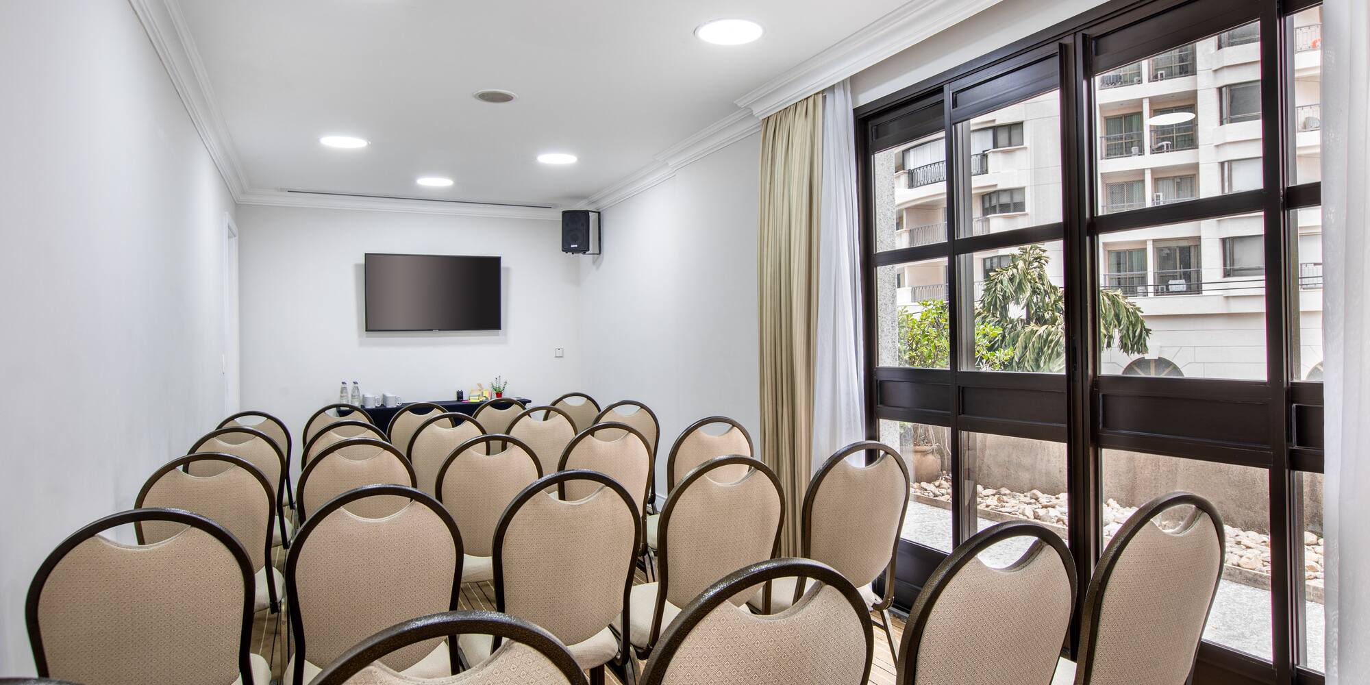 a room with chairs and a television