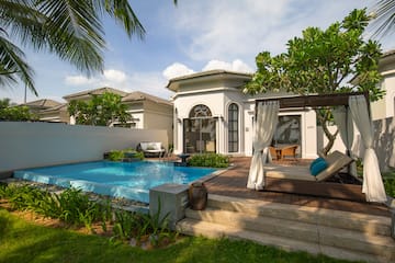 a pool with a bed and a patio in the back