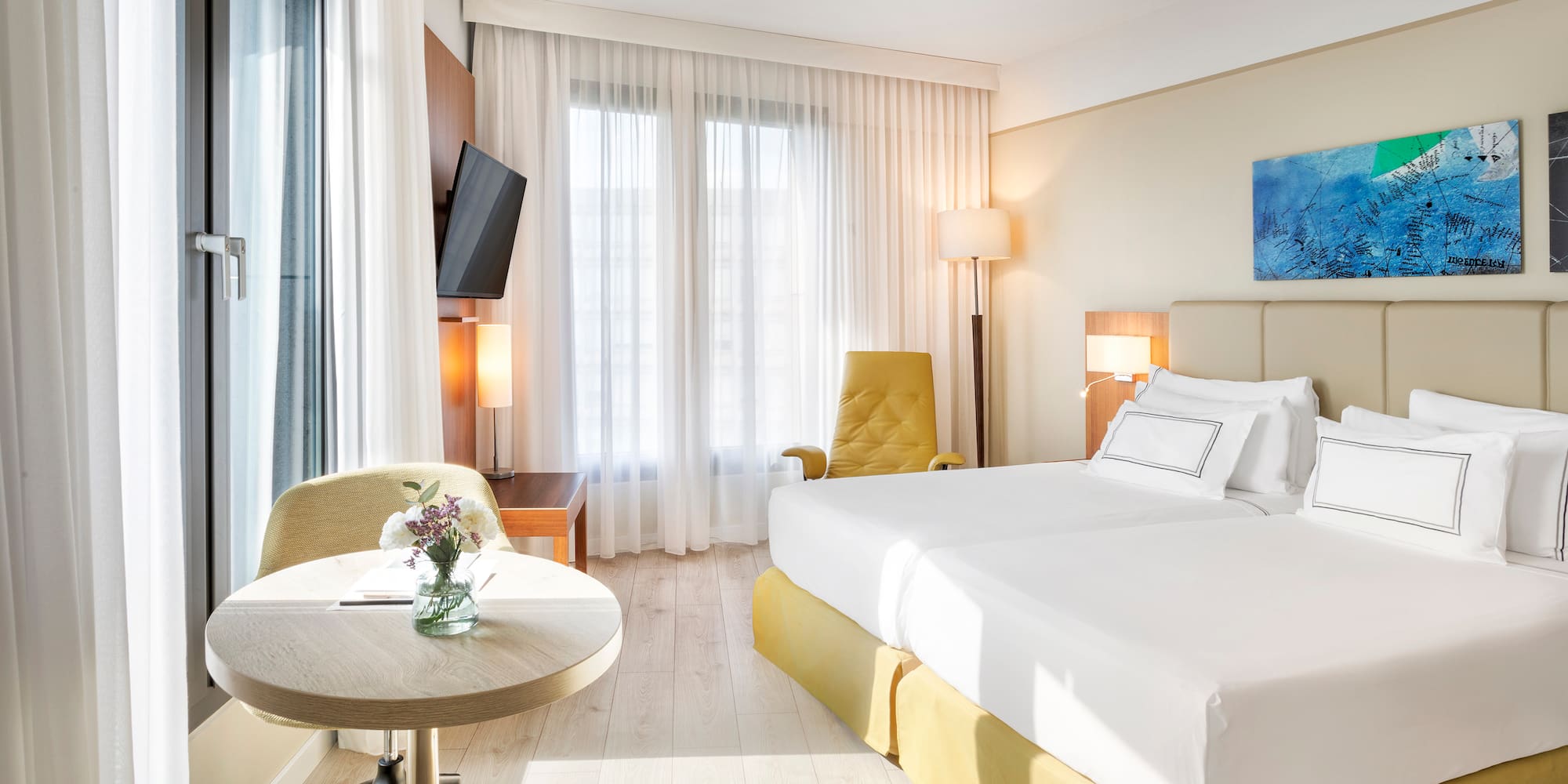 a room with two beds and a table