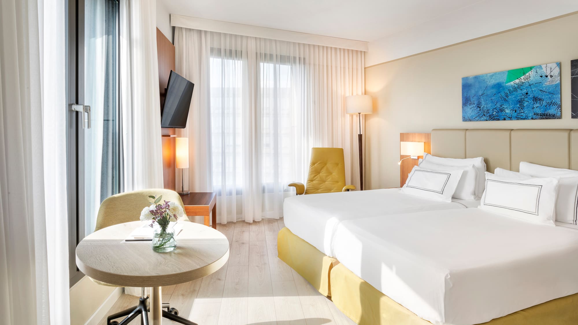 a room with two beds and a table