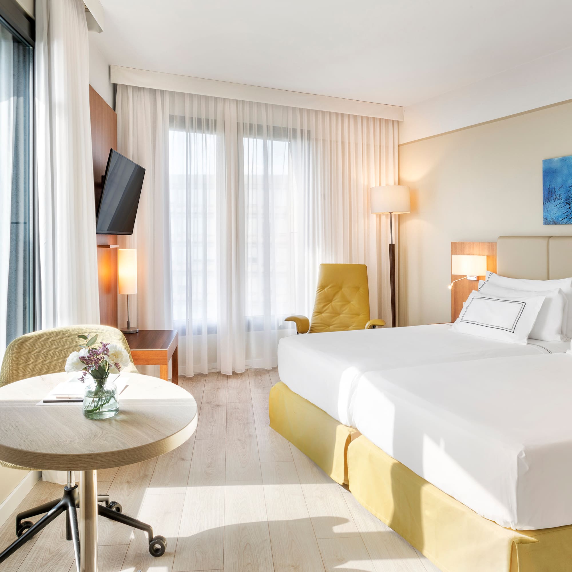 a room with two beds and a table