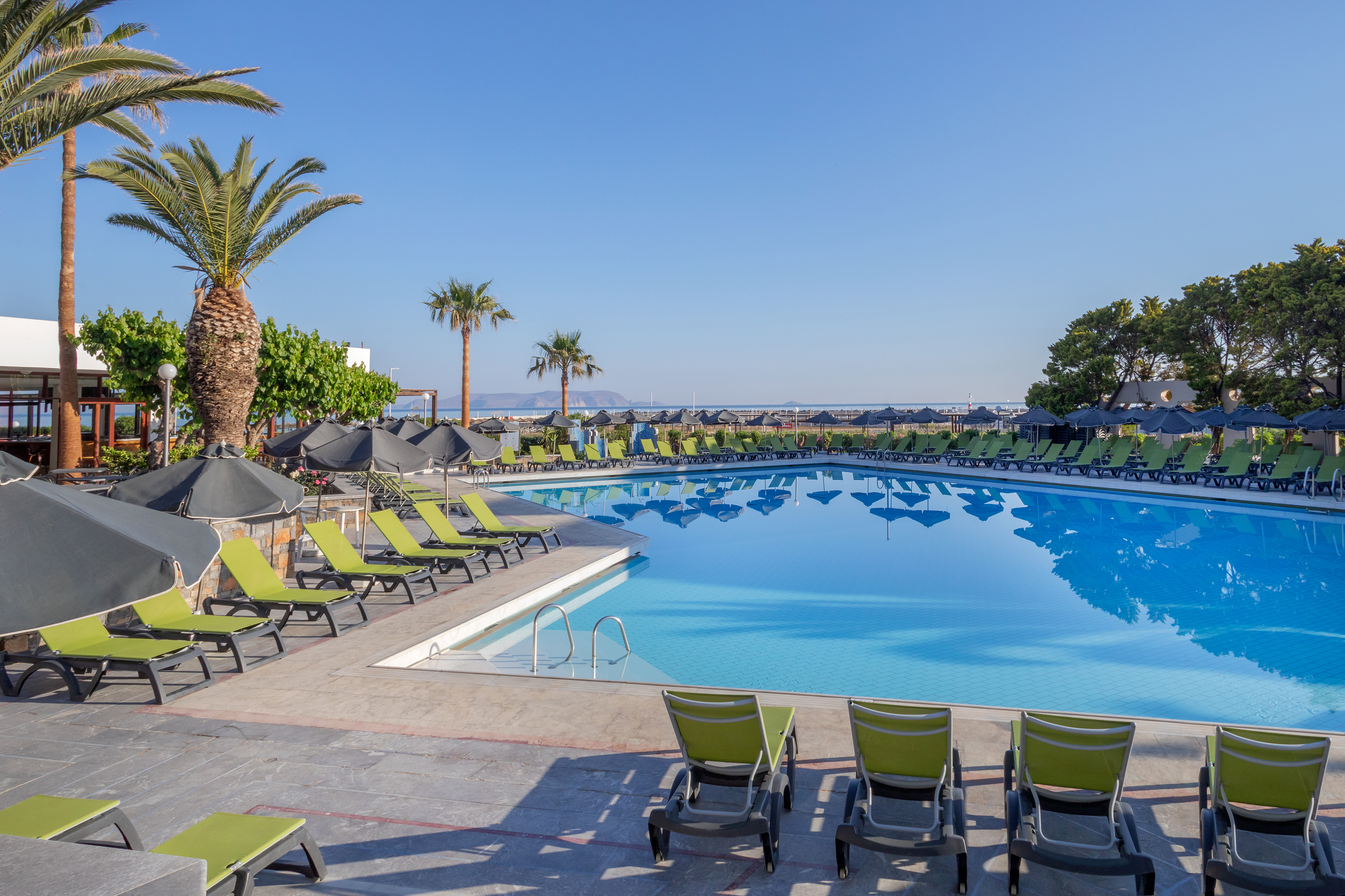 a pool with lounge chairs and umbrellas