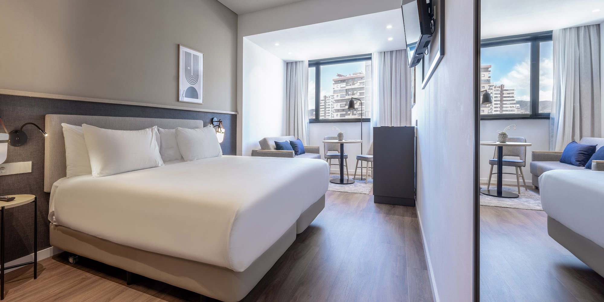 a room with a bed and a television