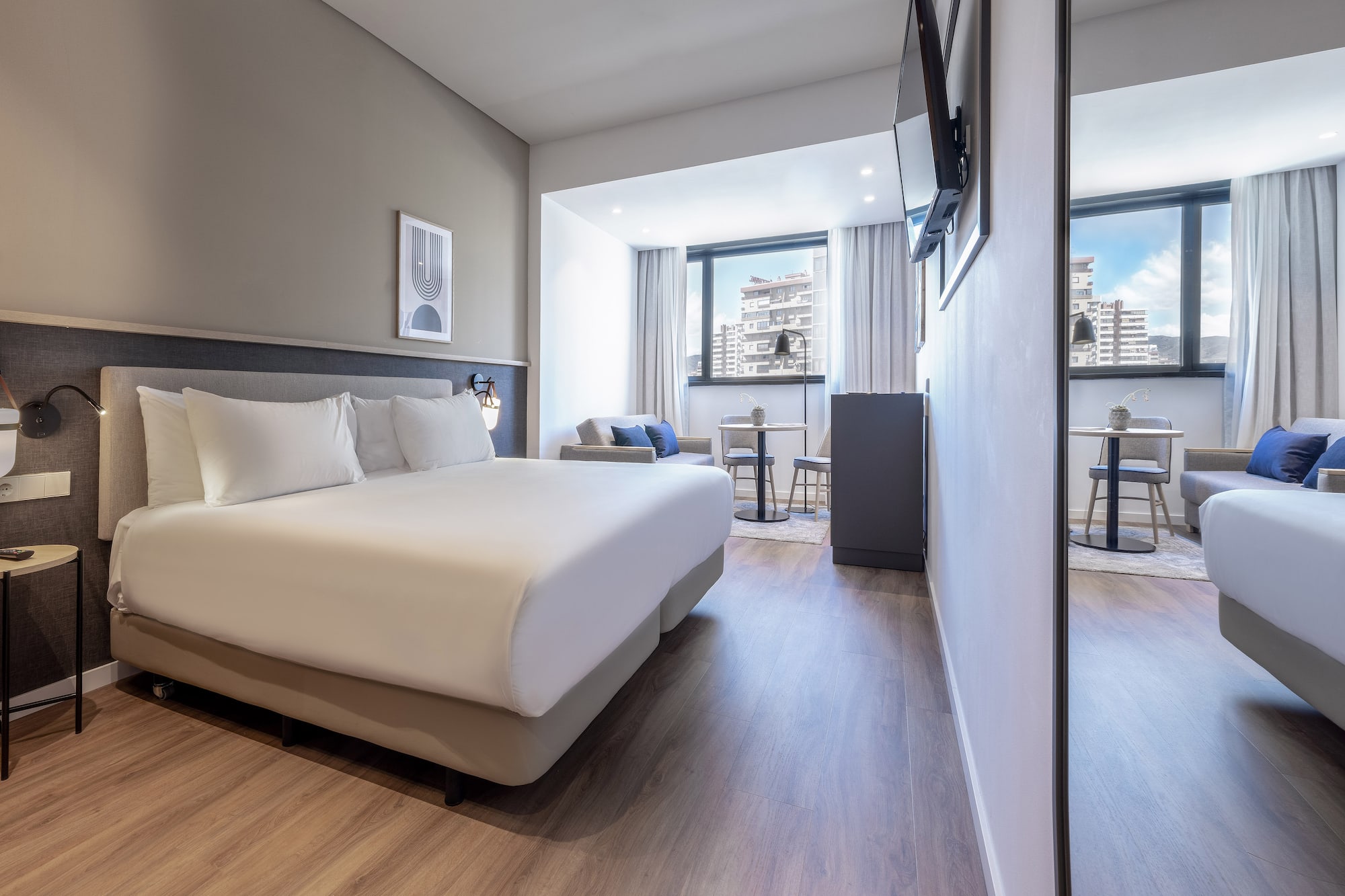 a room with a bed and a television