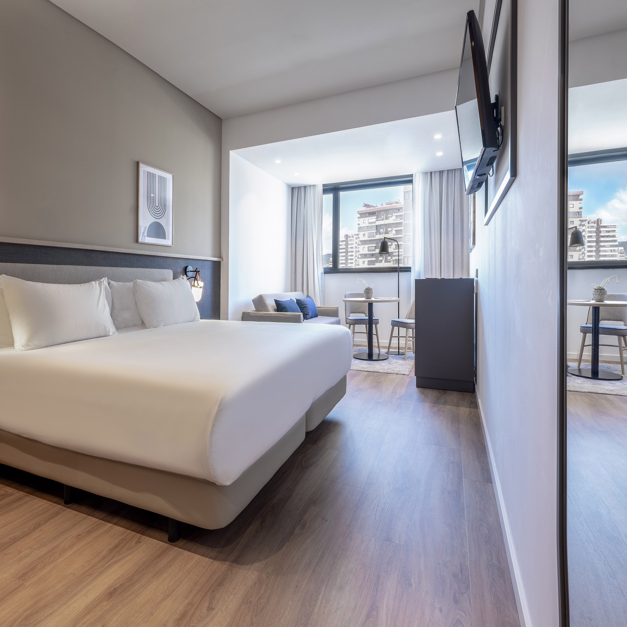 a room with a bed and a television