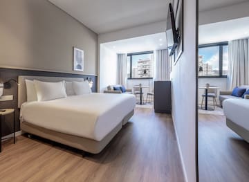 a room with a bed and a television