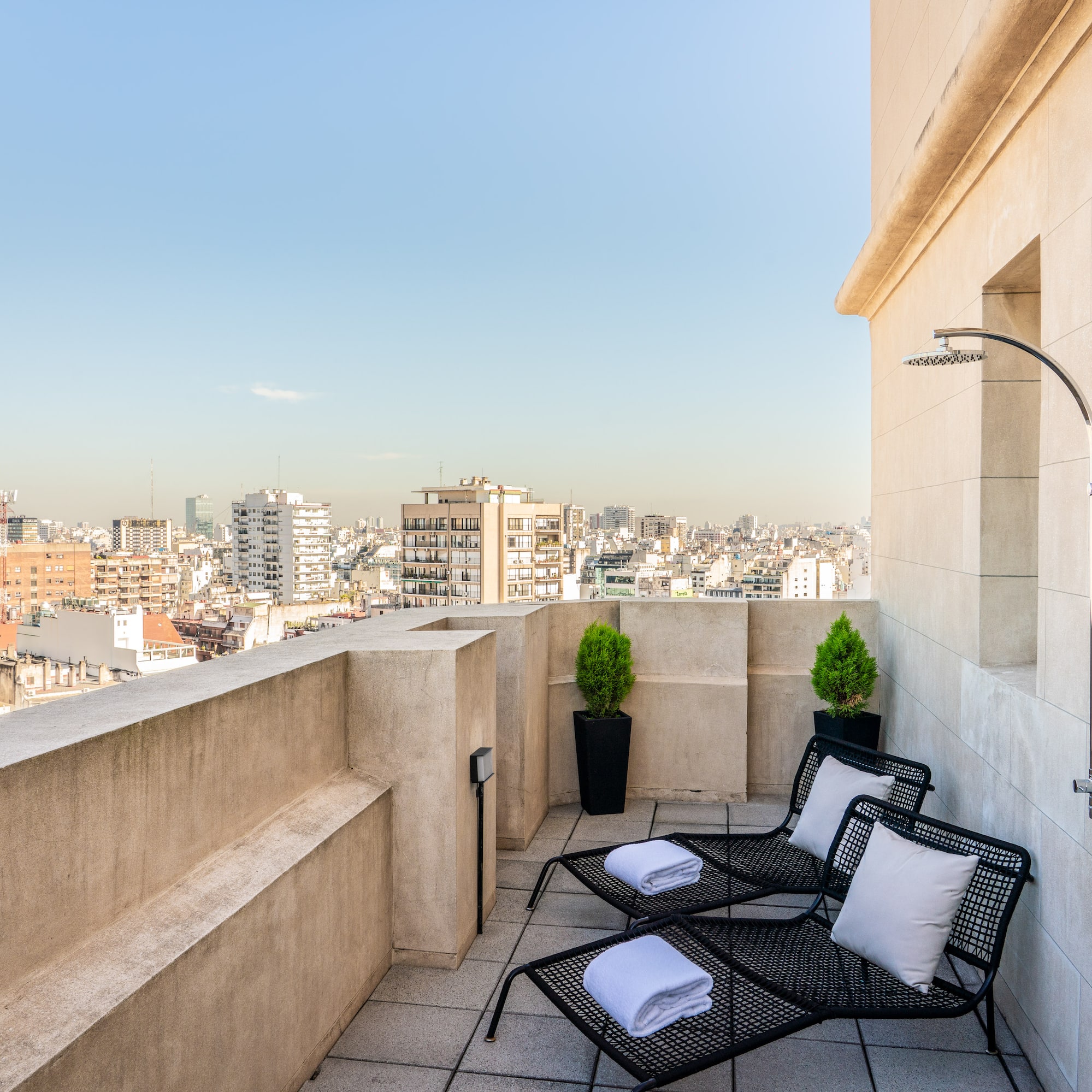 a deck with chairs and a shower