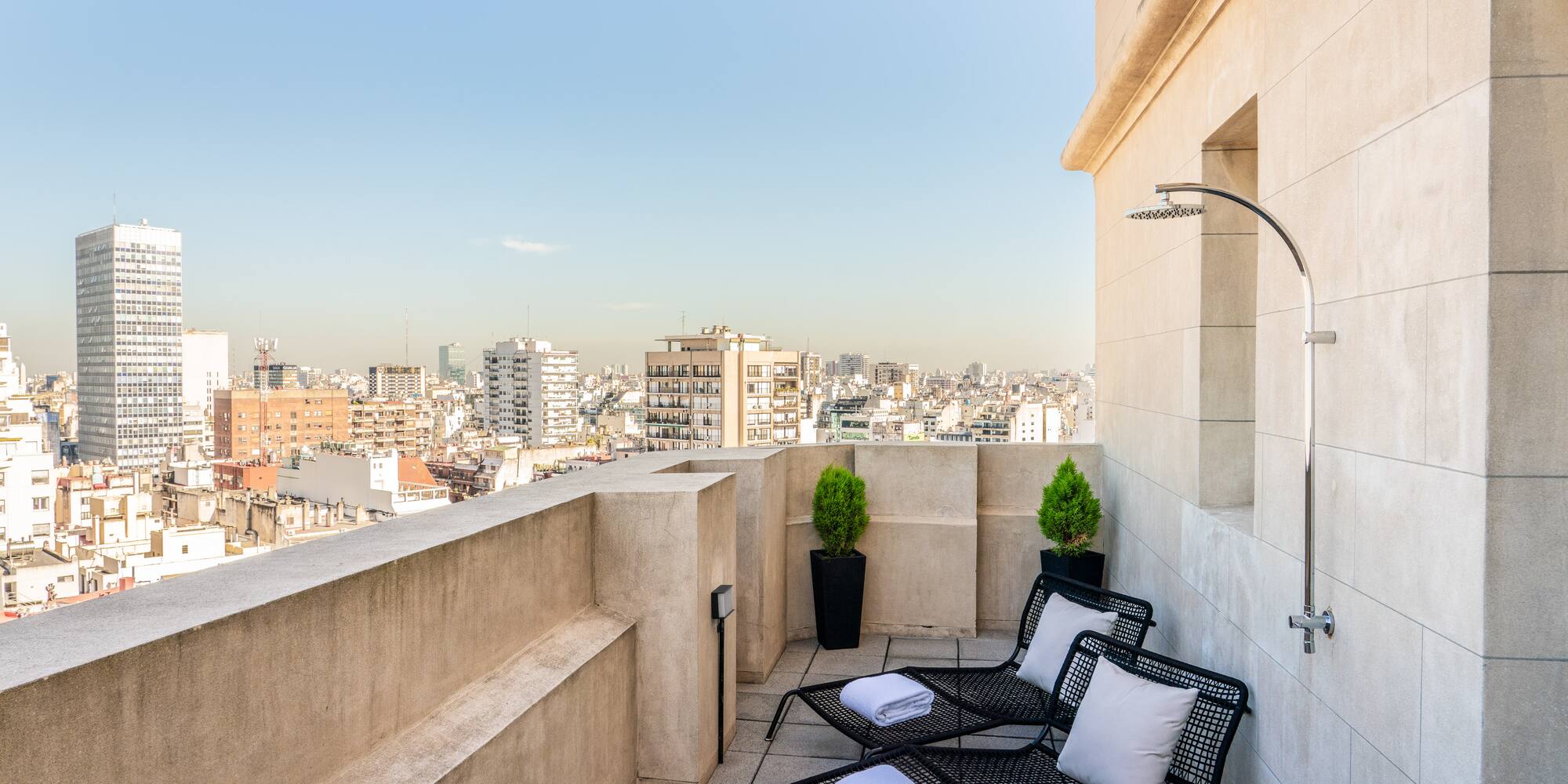 a deck with chairs and a shower