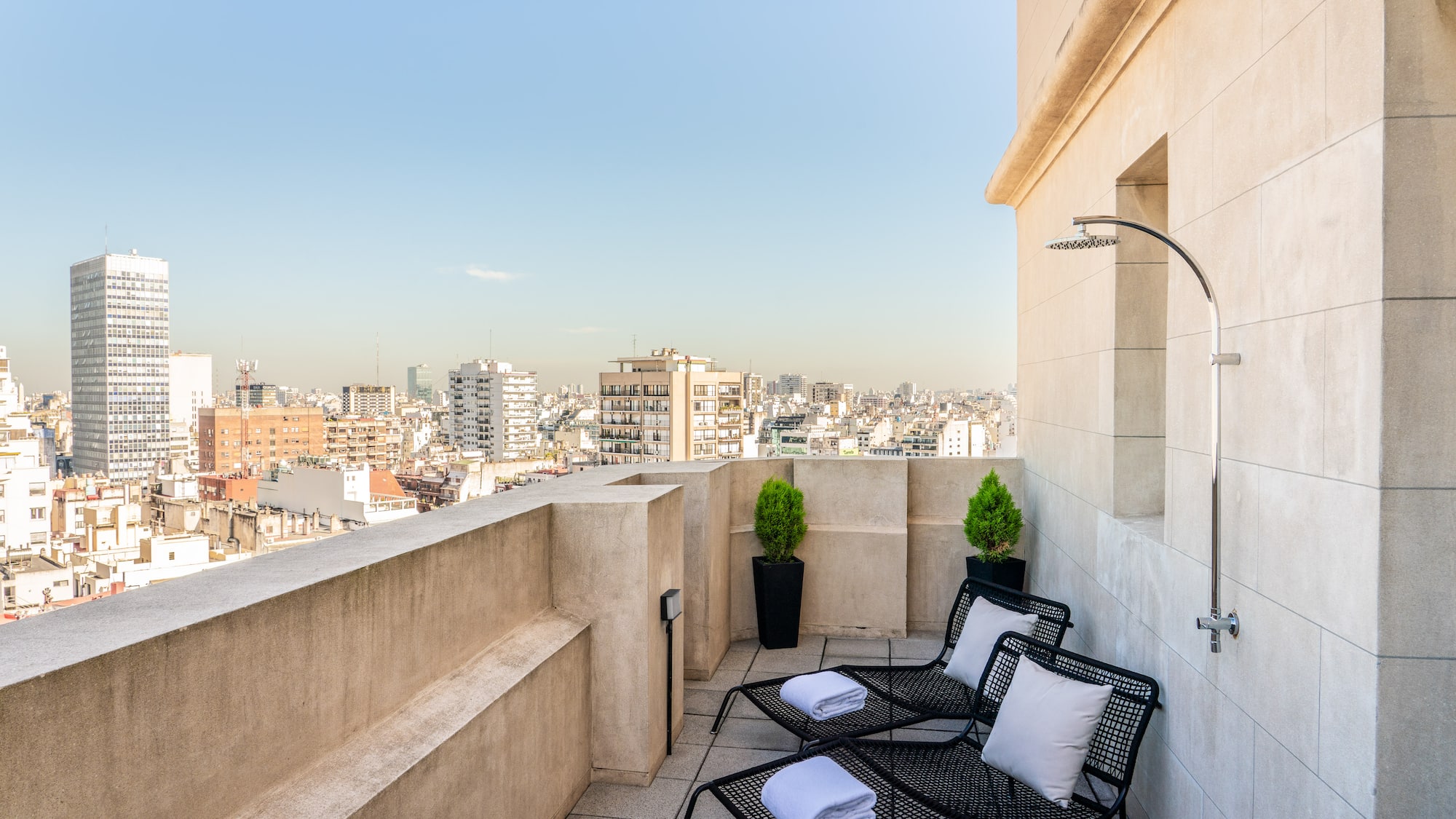 a deck with chairs and a shower