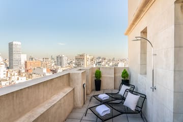 a deck with chairs and a shower