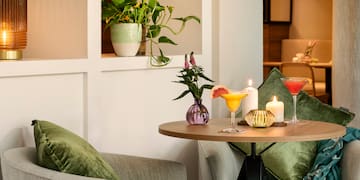 a table with drinks and candles on it