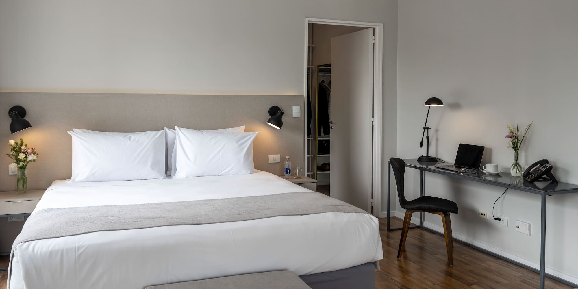 a bedroom with a desk and a bed