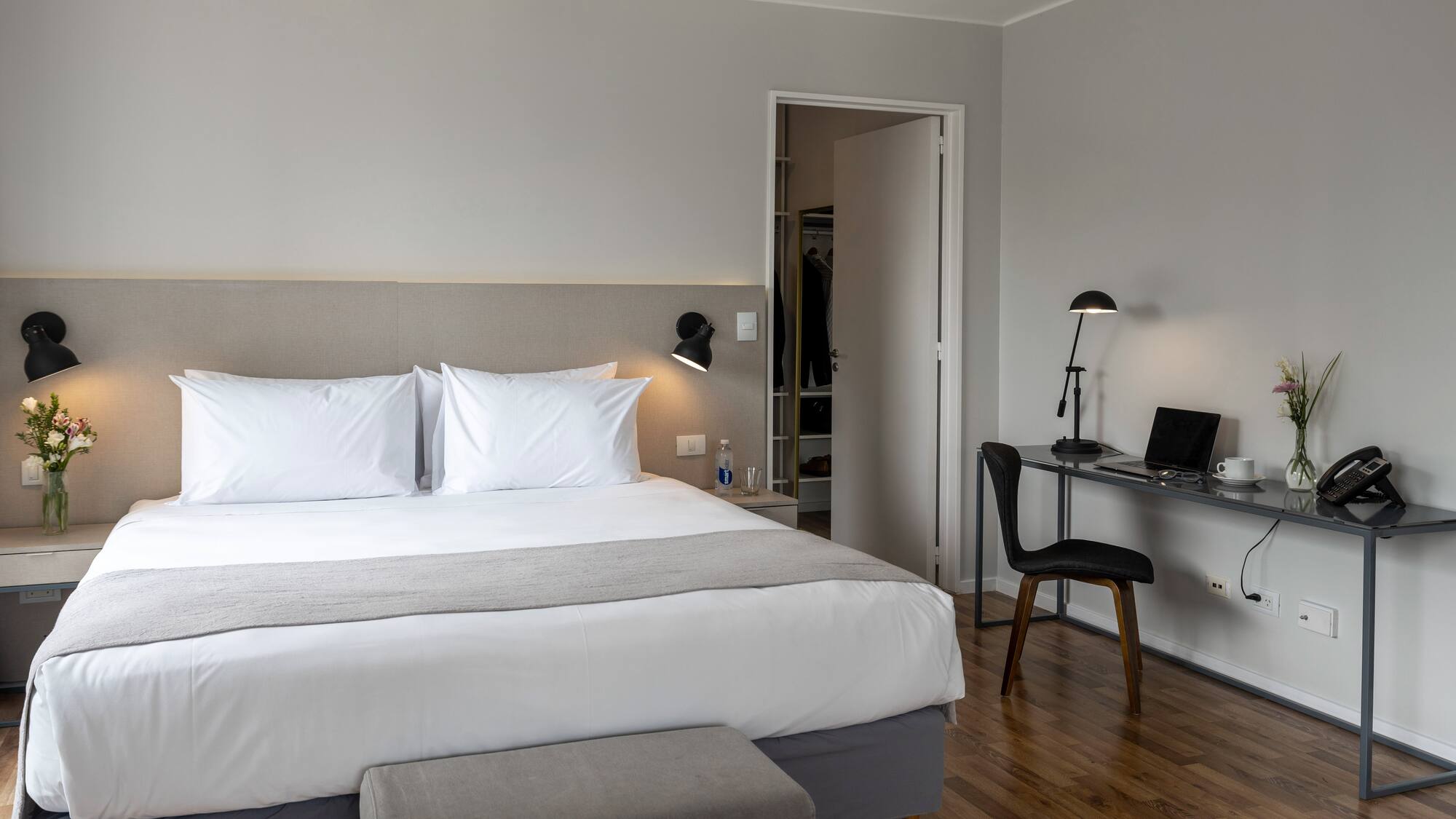 a bedroom with a desk and a bed