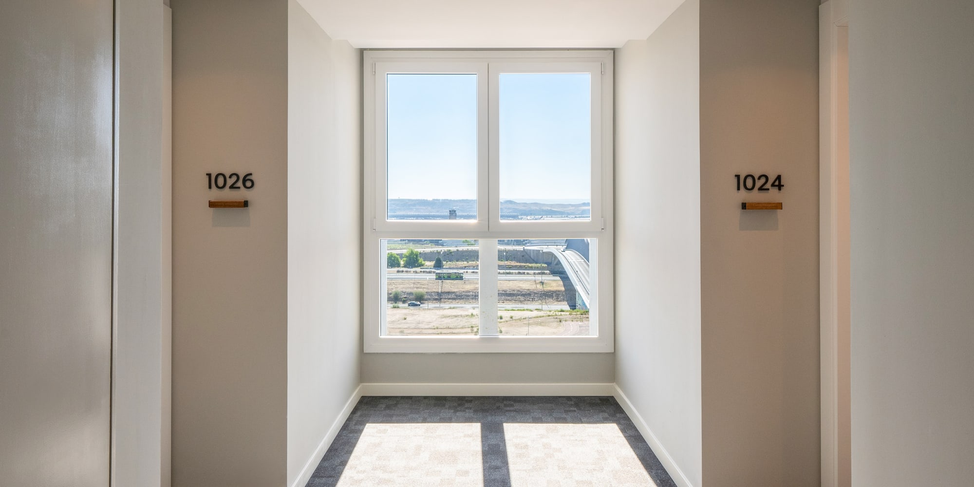 a room with a window and a view of the city