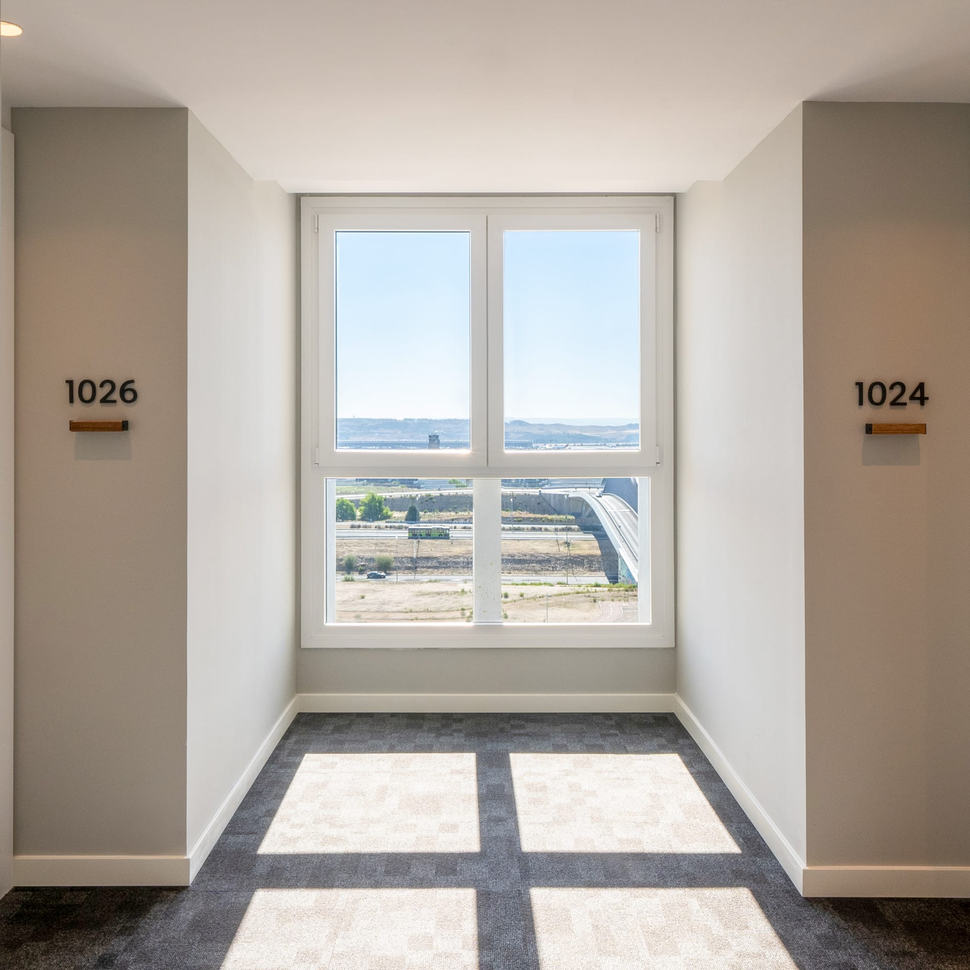 a room with a window and a view of the city