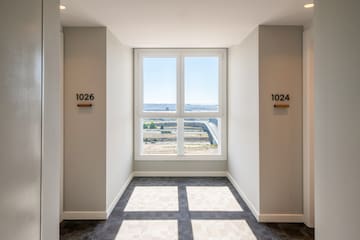 a room with a window and a view of the city