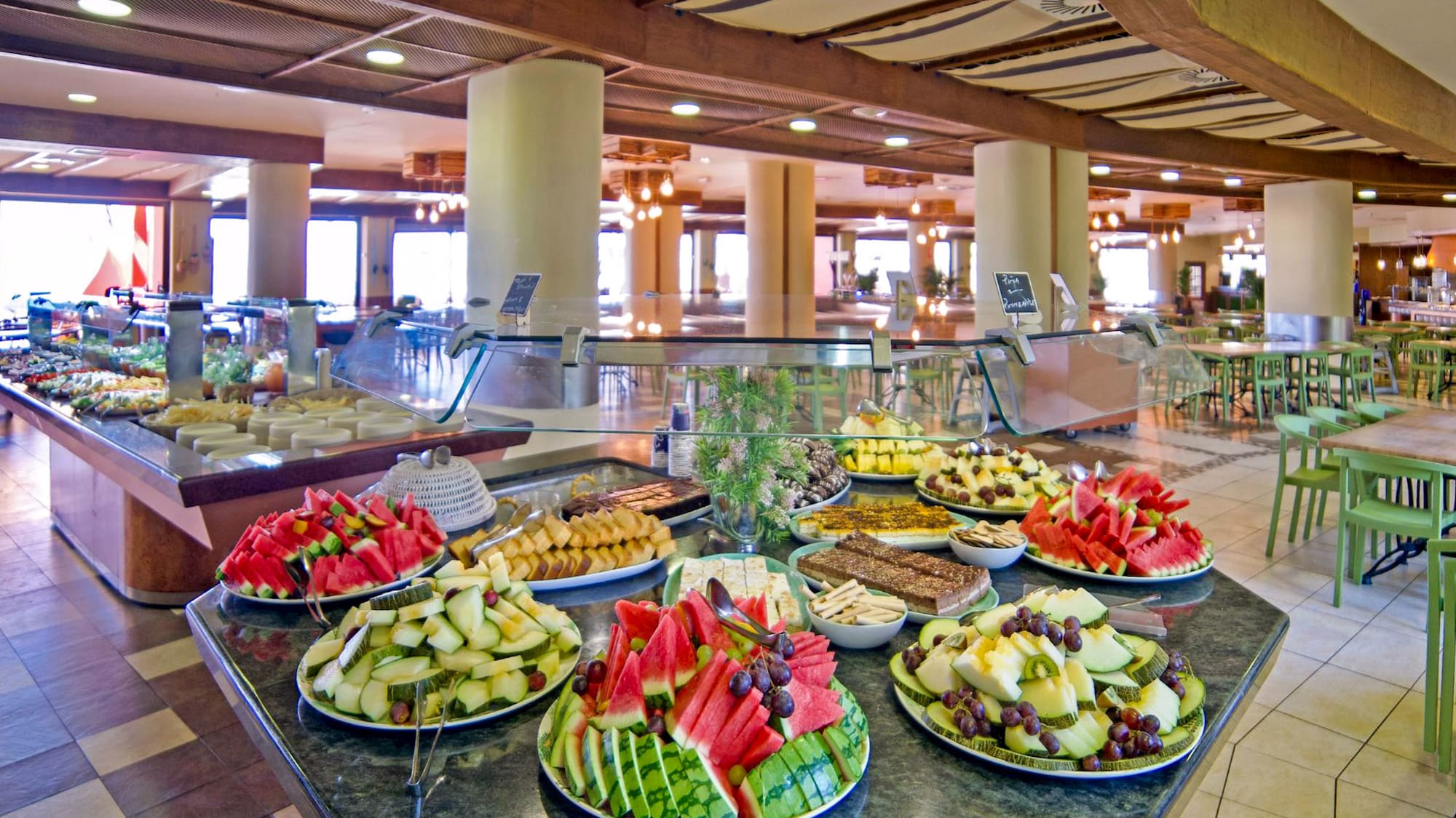 a buffet table with plates of fruit