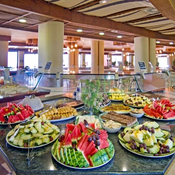 a buffet table with plates of fruit