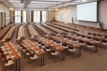 a large conference room with tables and chairs