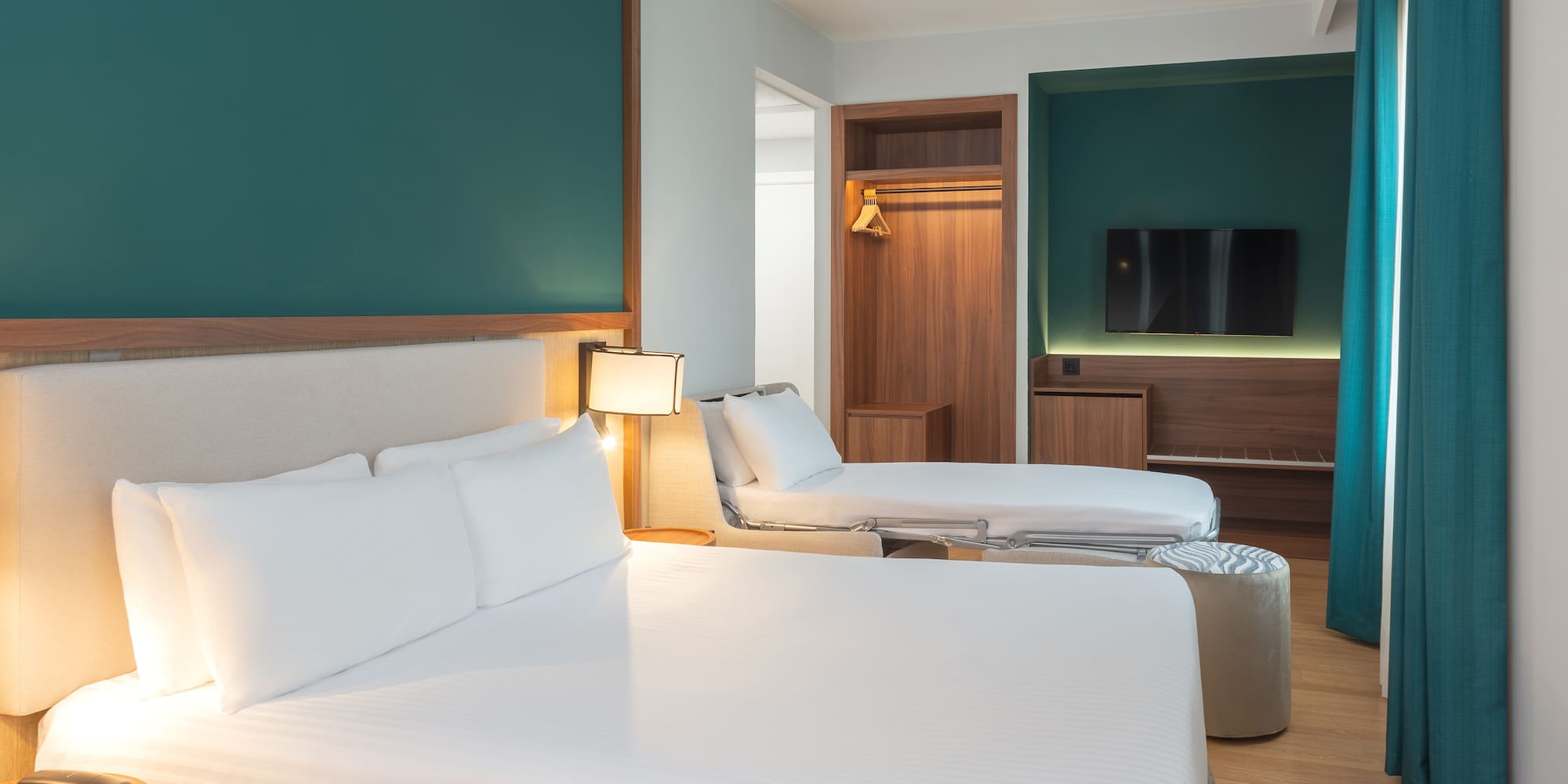 a room with two beds and a tv