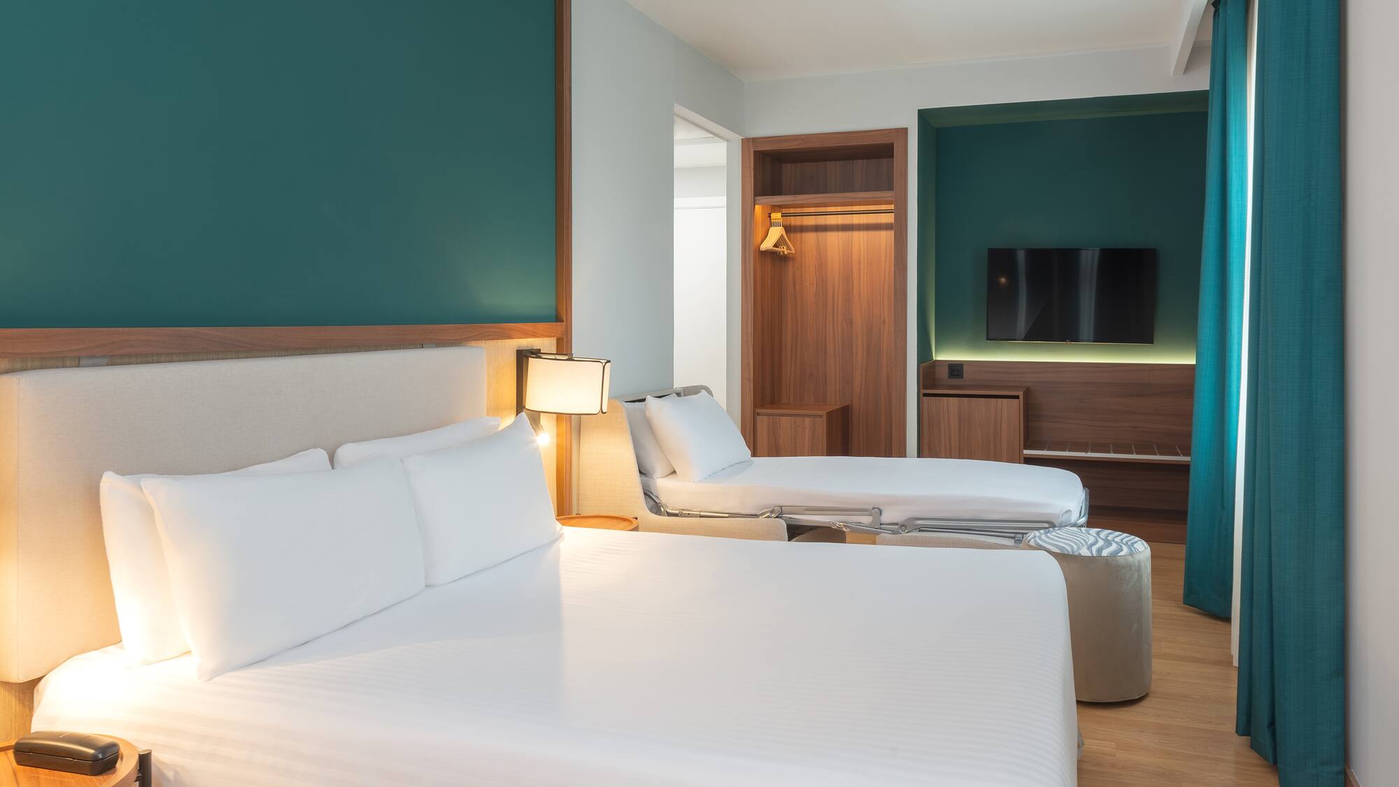 a room with two beds and a tv