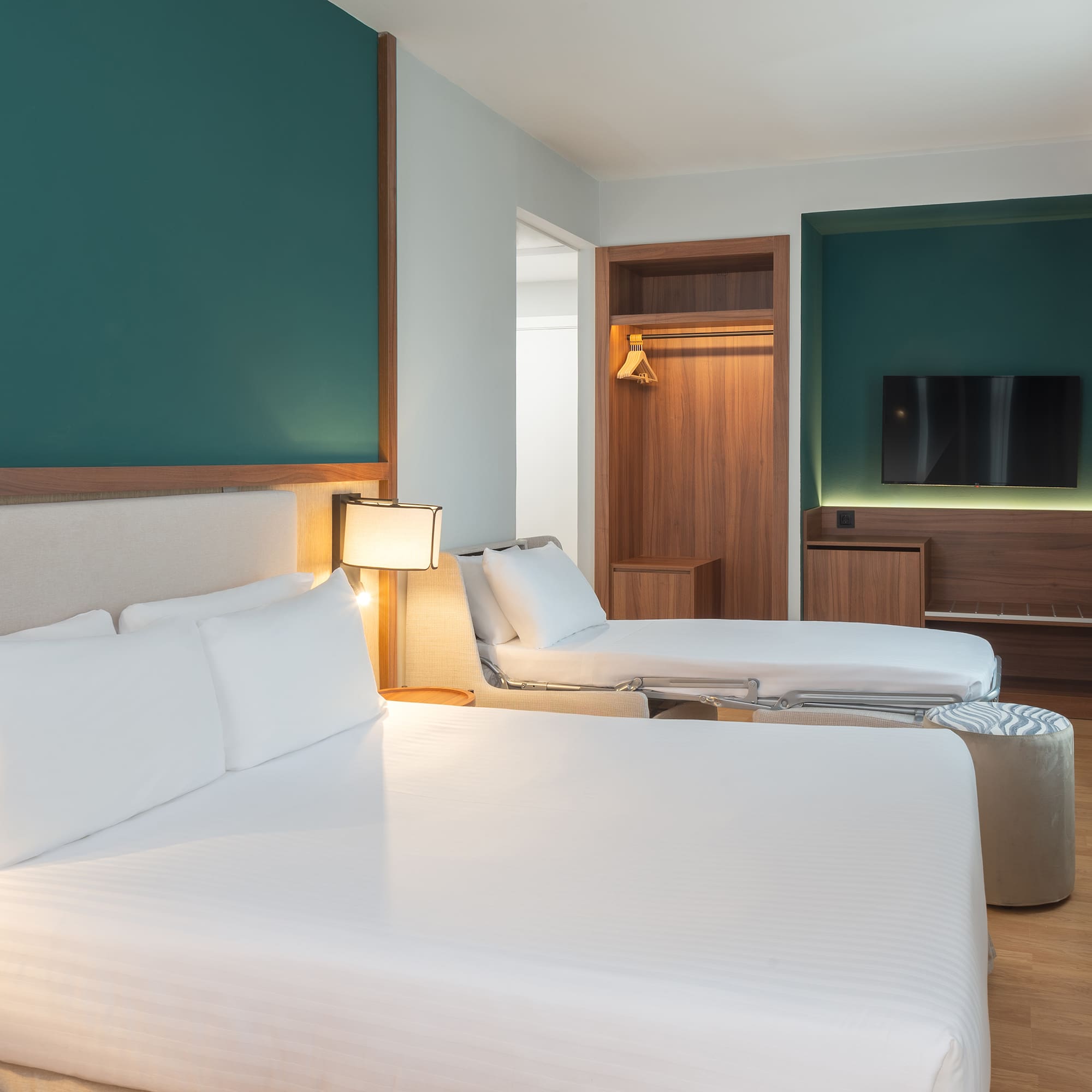 a room with two beds and a tv