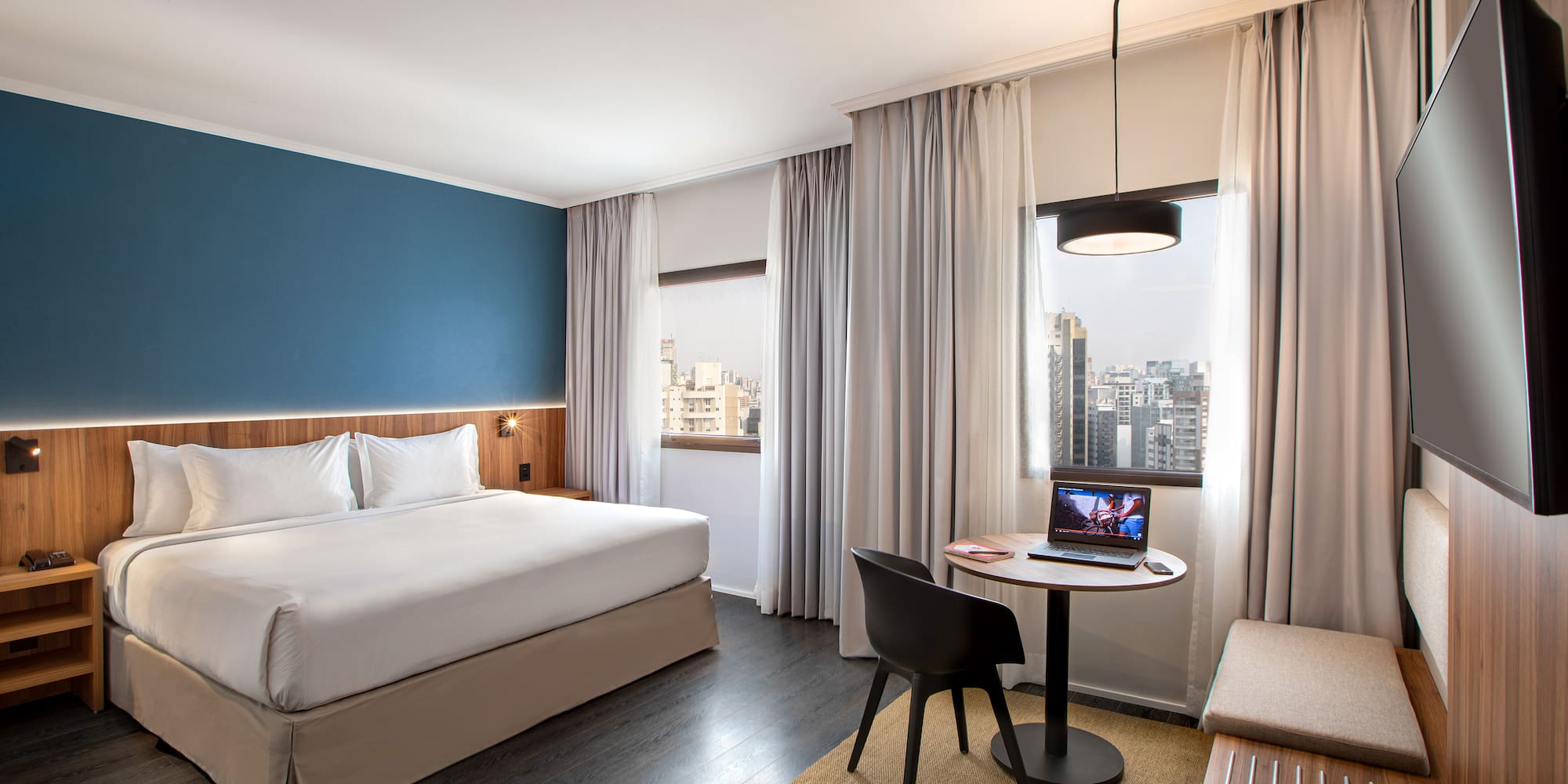 a room with a bed and a table and chairs