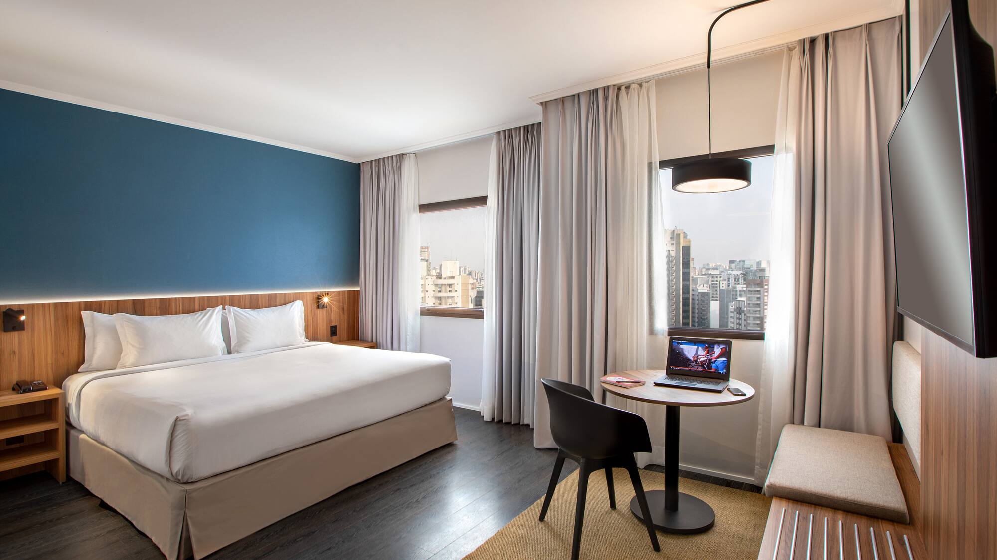 a room with a bed and a table and chairs