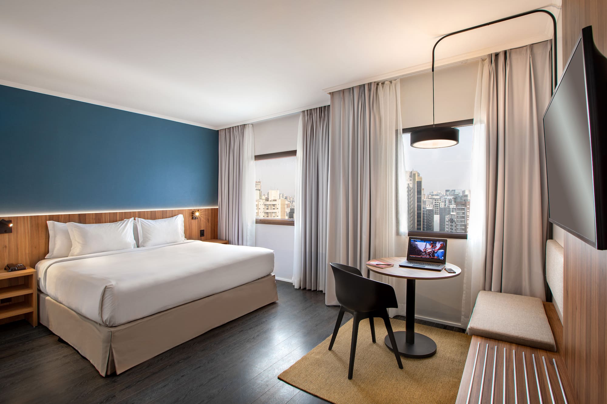 a room with a bed and a table and chairs