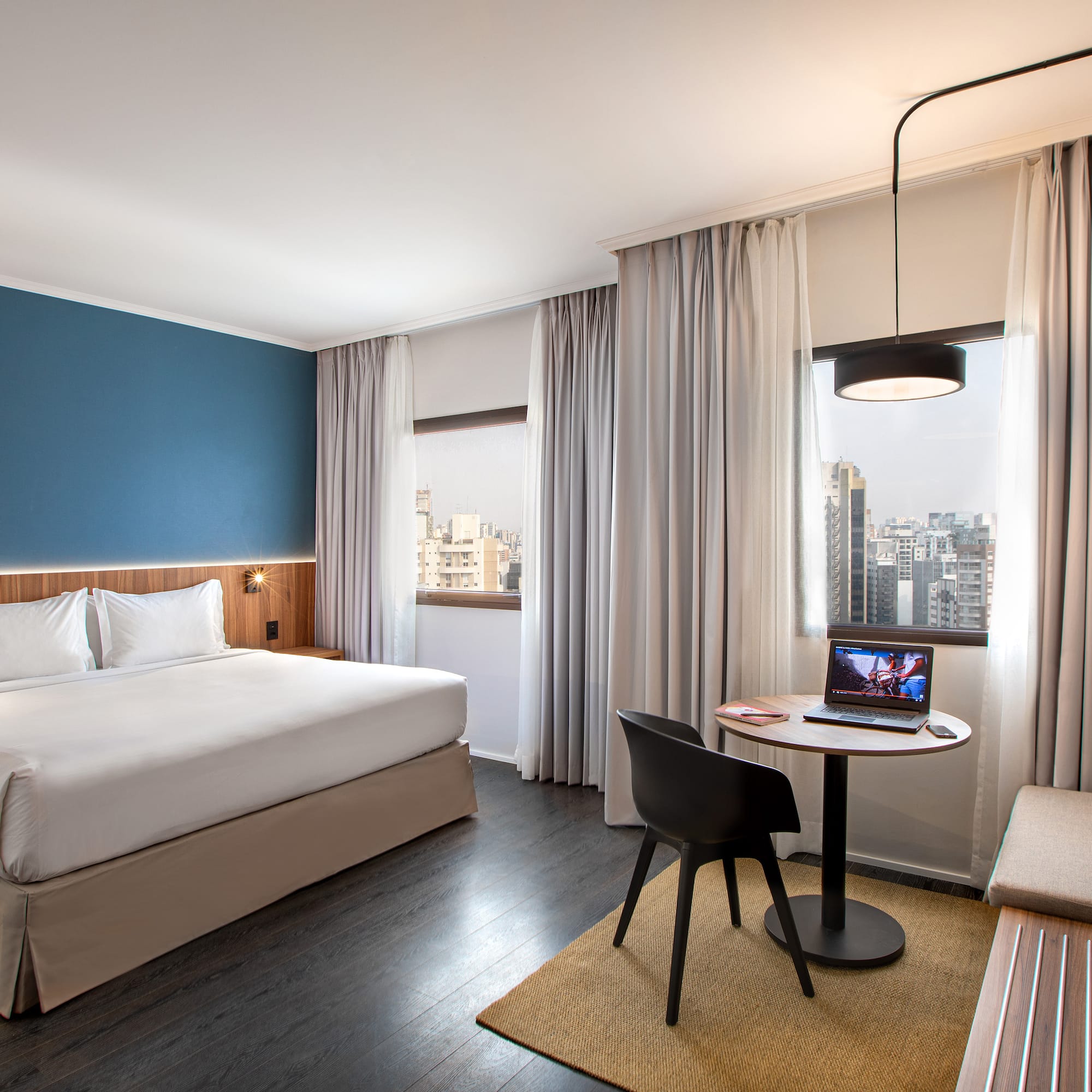 a room with a bed and a table and chairs