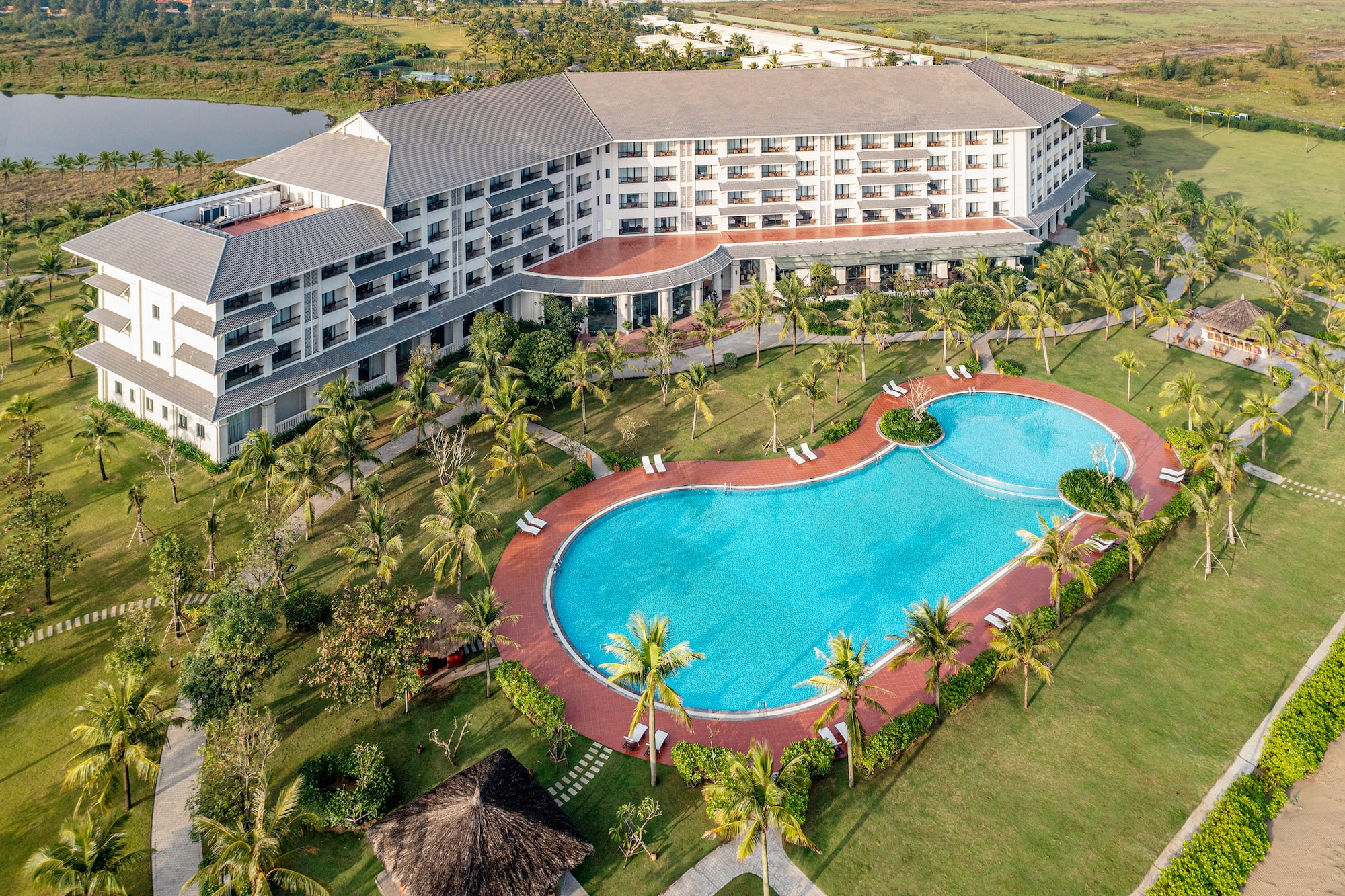 a swimming pool and a building with trees around it