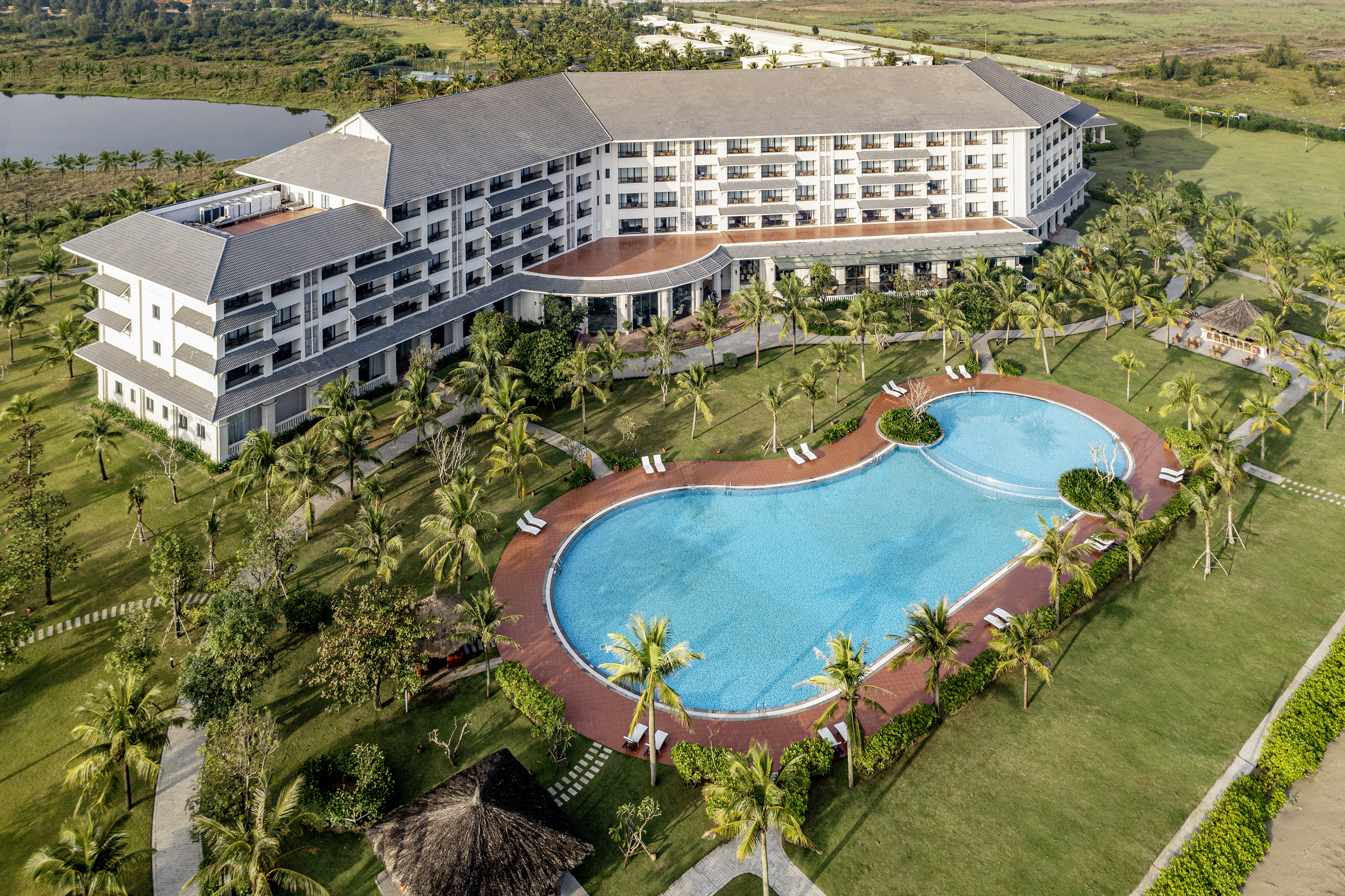 a swimming pool and a building with trees around it