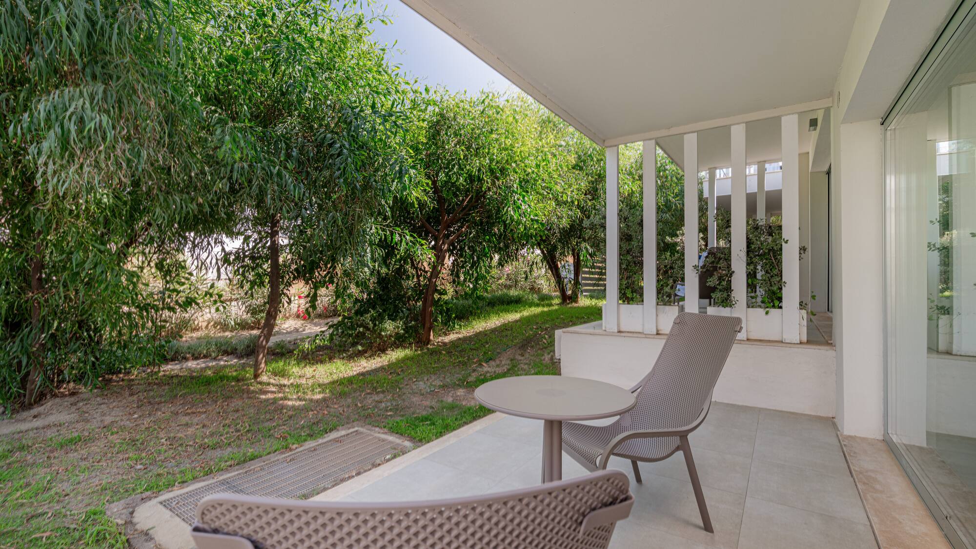 a patio with chairs and a table
