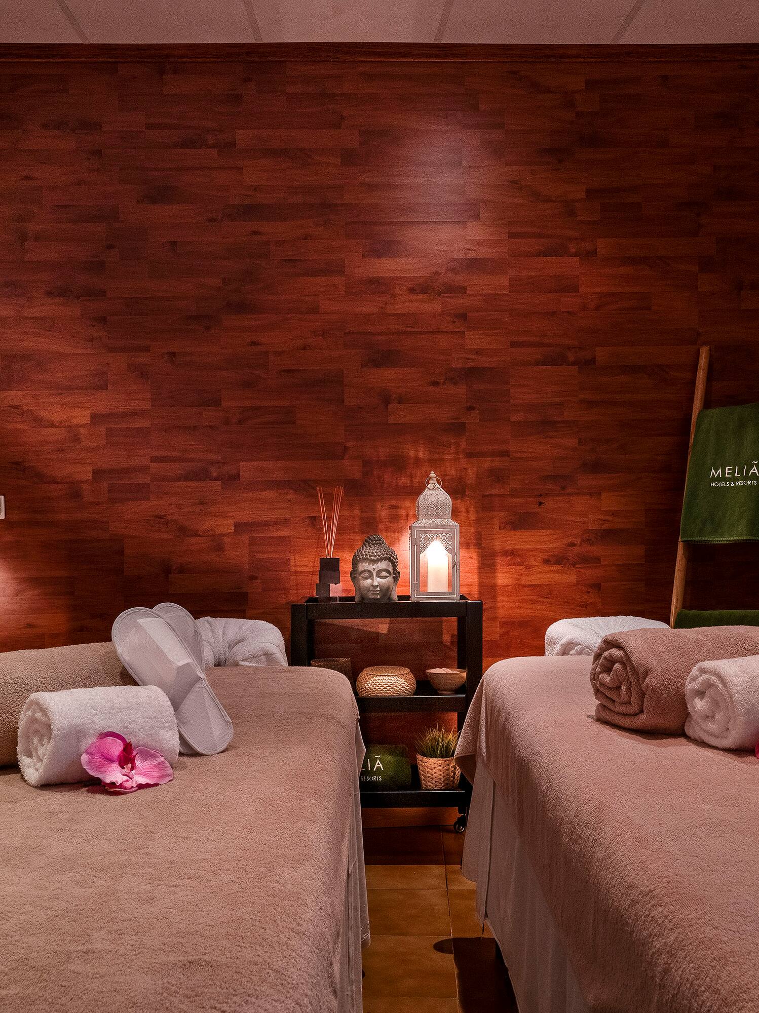 a room with two beds and candles