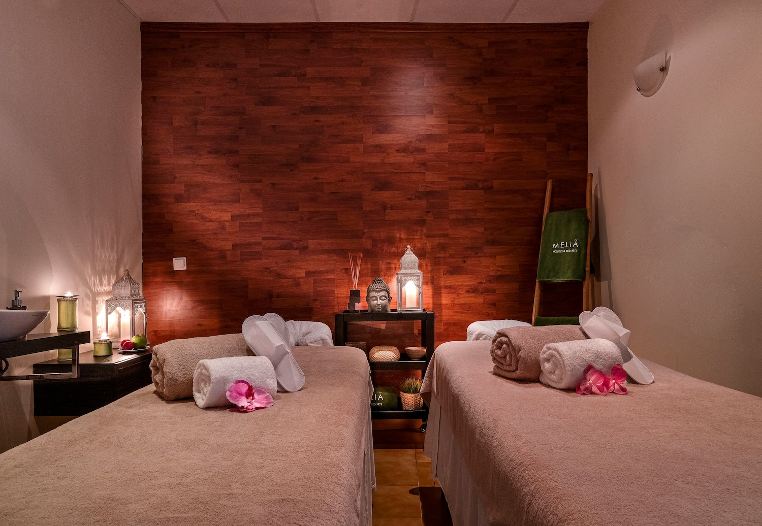 a room with two beds and candles