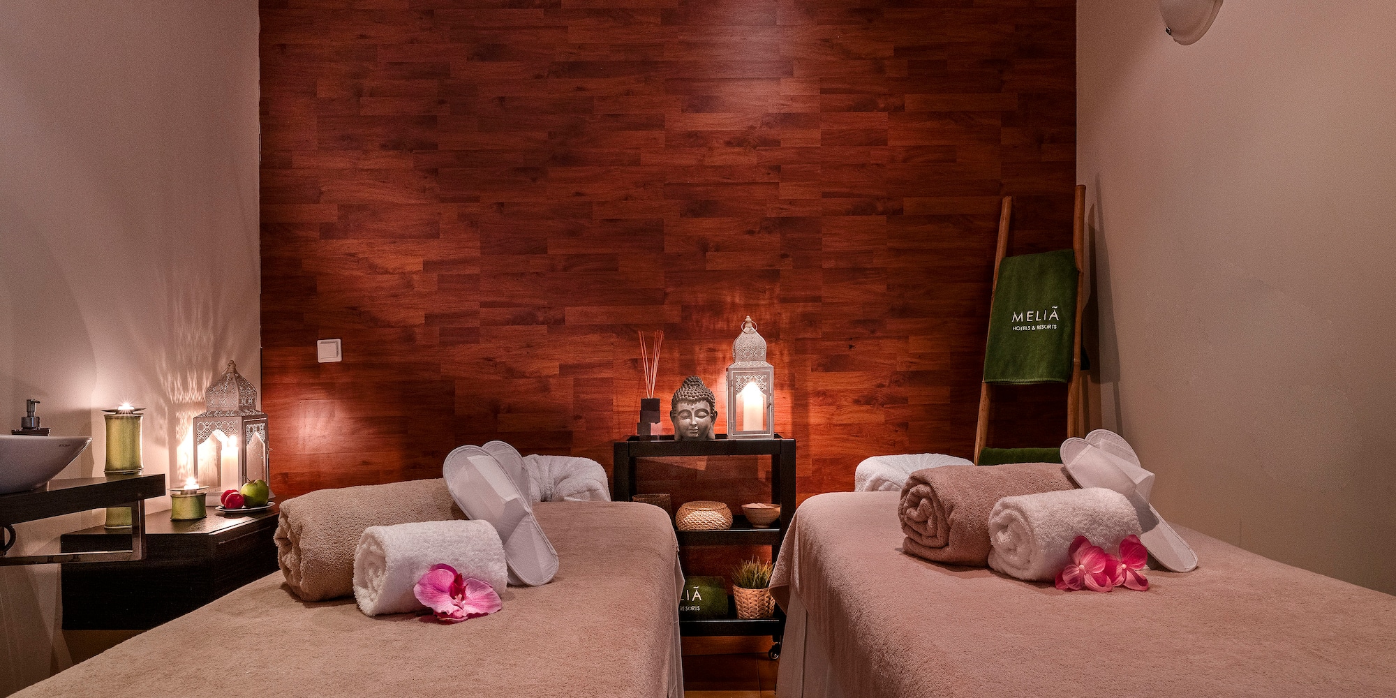 a room with two beds and candles